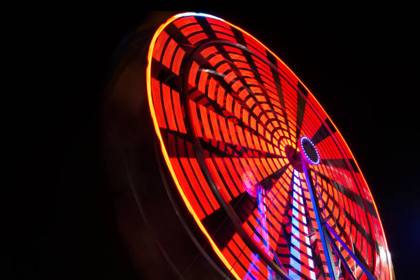 grande roue de nuit - blurred motion amusement park spinning lighting equipment photos et images de collection