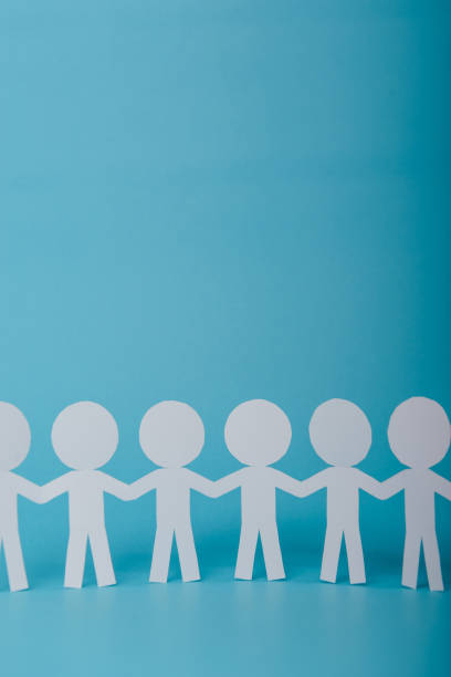 istock abstract paper people holding for hands 997210260