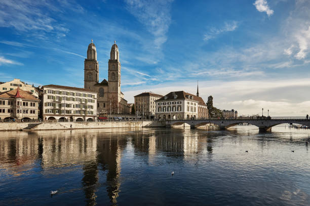 View of historic city of Zurich. Grossmunster Church and Munsterbucke crossing river Limmat, Canton of Zurich, Switzerland View of historic city of Zurich. Grossmunster Church and Munsterbucke crossing river Limmat, Canton of Zurich, Switzerland. Europe zurich photos stock pictures, royalty-free photos & images