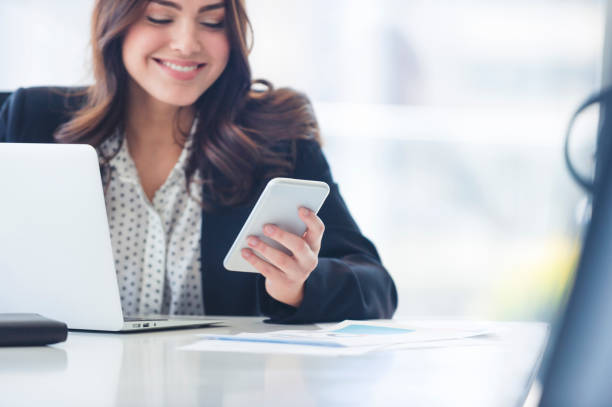 istock Business woman texting on a mobile phone. 997231528
