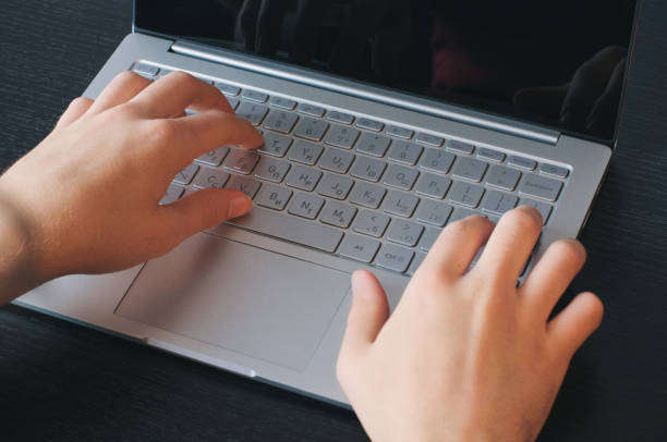 istock Man working on laptop and typing on the wooden desk 997267006