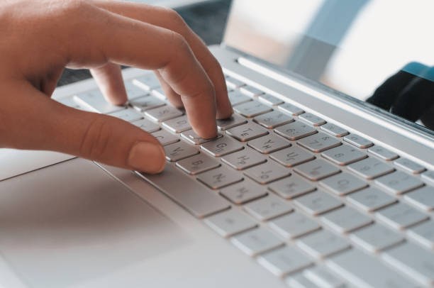 istock Man's hand on the laptop keyboard close-up. Typing a message 997268740