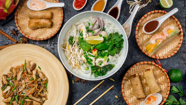 istock Assorted asian dinner, vietnamese food. Pho ga, pho bo, noodles, spring rolls 997276402