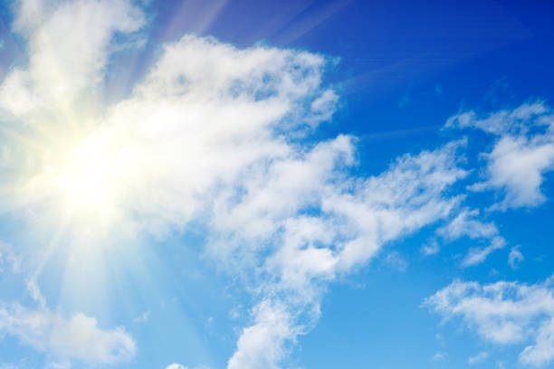 istock clouds against a blue sky with rays of the sun 997287056