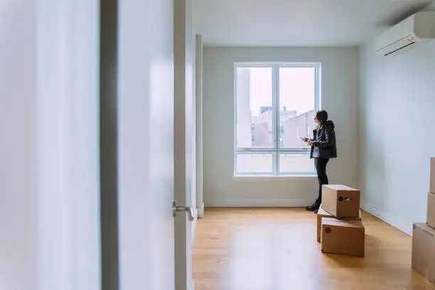 Photo of Teenager girls, sisters, looking around the new empty apartment