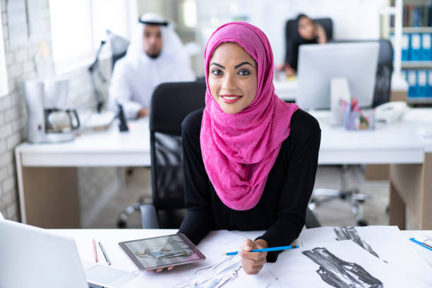 istock Smiling arab woman working in fashion studio 997290100