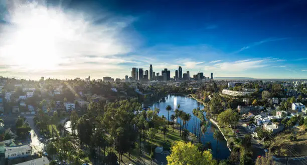 Aerial panorama of Echo Park Lake in Los Angeles, surrounded by the neighborhood that bears its name, with the Downtown LA skyline in the distance.