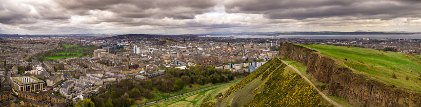Aerial panorama of Edinburgh from above Salisbury Crags, looking over the city towards Leith and the Firth of Forth.