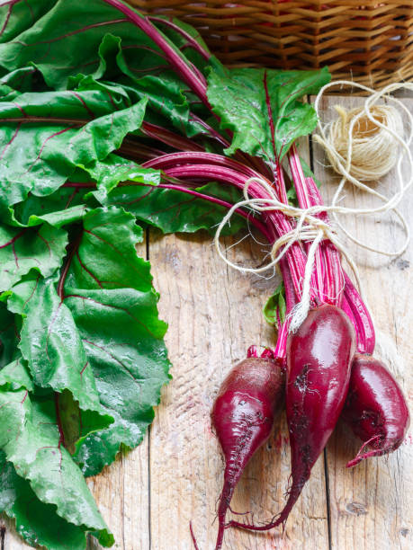istock Organic red beets (beetroot)  with green leaves on an old wooden table. Rustic style 997323608