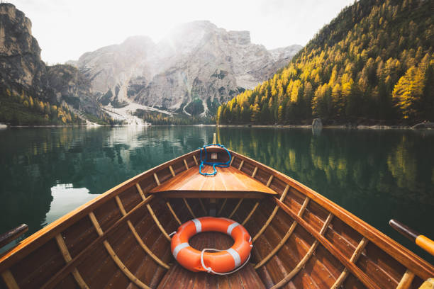 istock Traditional rowing boat on a lake in the Alps in fall 997324514