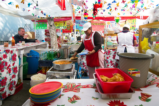 Mexico city, Mexico - 2018: Women sell traditional food at a street market at the Coyoacan neighborhood.
