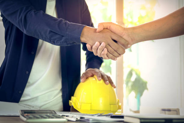 istock Engineer and architect shake hands agree deal of success that finish design and construction project 997333836