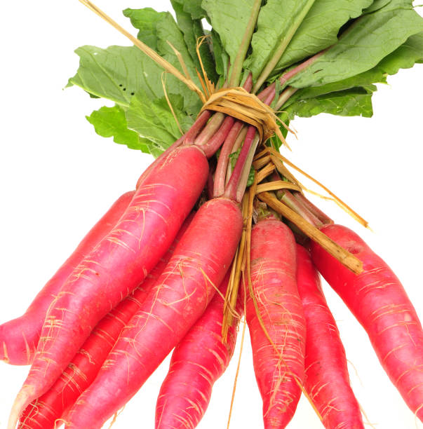 istock White leaves and long red radish  on a white background 997341720