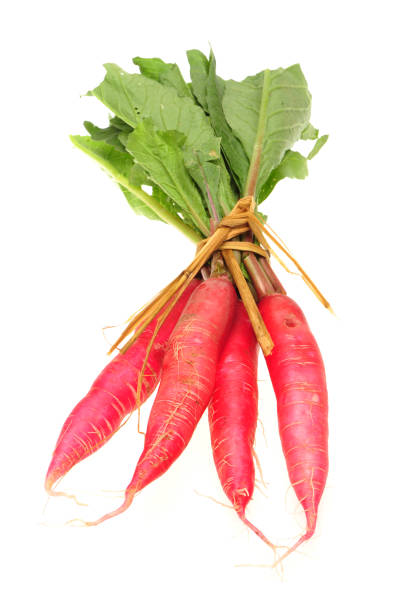istock White leaves and long red radish  on a white background 997341824