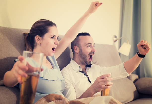 istock Couple is watching football on the sofa 997346802