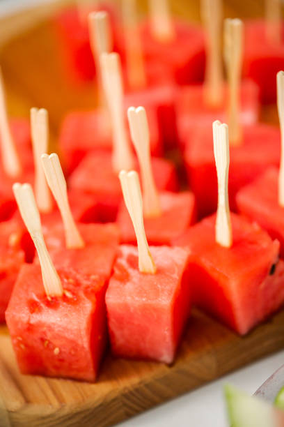 istock Preparing watermelon appetizers dipped in chocolate 997350526