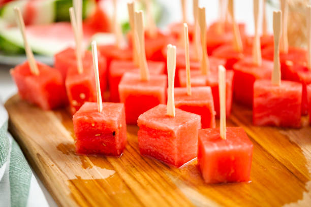 istock Preparing watermelon appetizers dipped in chocolate 997350542