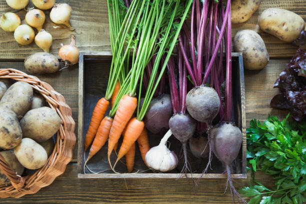 istock Harvest fresh vegetables from carrot, beetroot, onion, garlic on old wooden board. Top view, rustic style. Copy space. 997358344