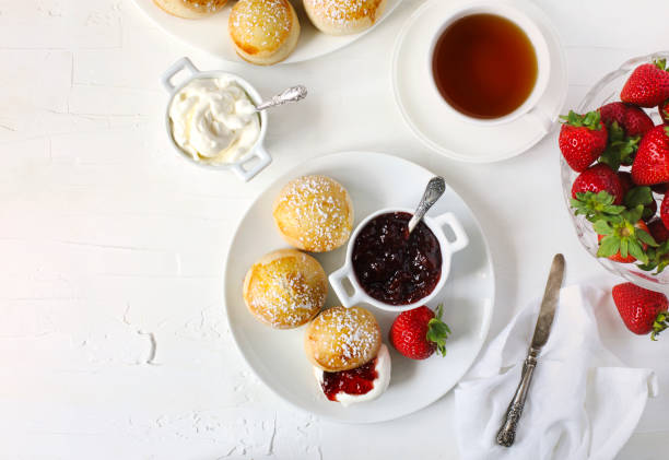 English scones with jam and whipped cream. English scones with jam and whipped cream, top view scone photos stock pictures, royalty-free photos & images