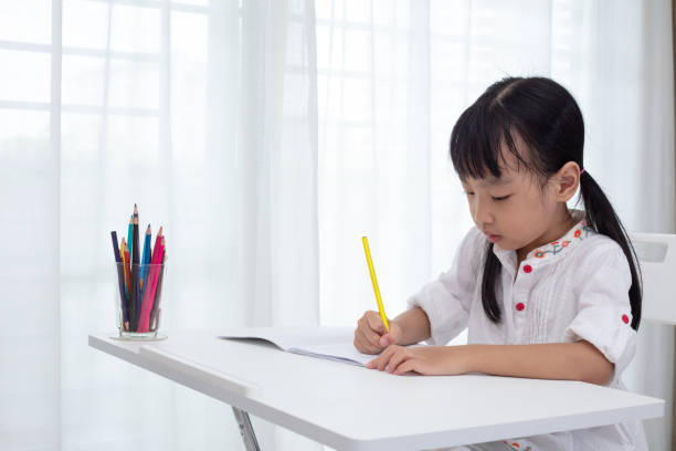 istock Asian Little Chinese girl doing homework 997366310