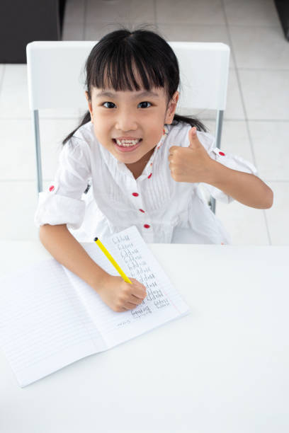 istock Asian Little Chinese girl doing homework 997366332