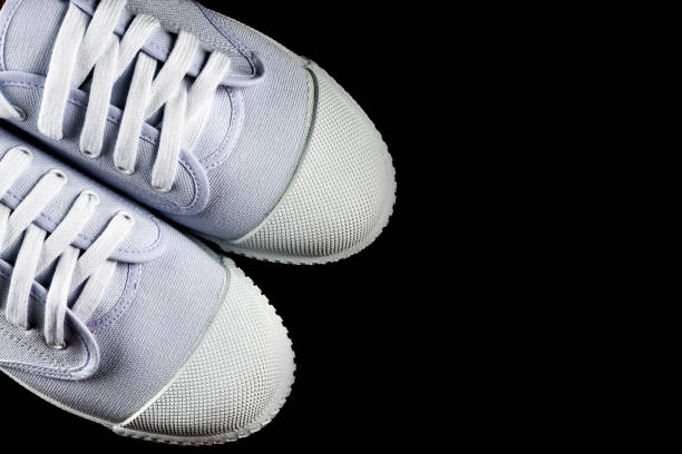 istock Top View White Sneakers isolated on black background 997370226