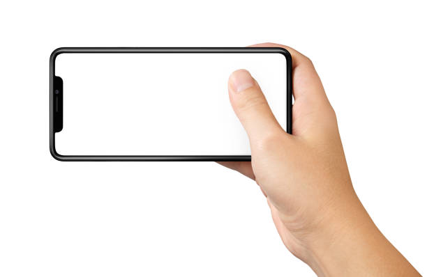istock Man hand holding the black smartphone with blank screen and modern frame less design isolated on white 997373248