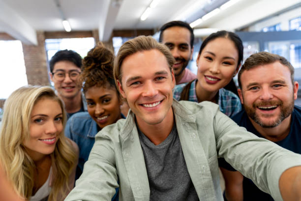 istock Happy group of coworkers taking a selfie at a creative office 997374100