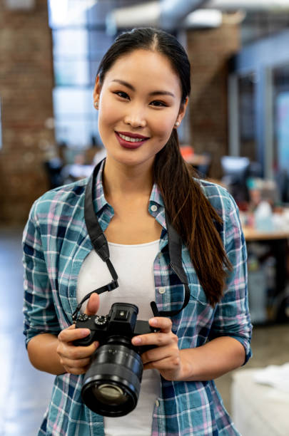 istock Asian photographer working at a creative office 997374134