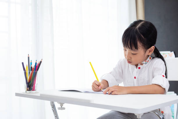 istock Asian Little Chinese girl doing homework 997376748