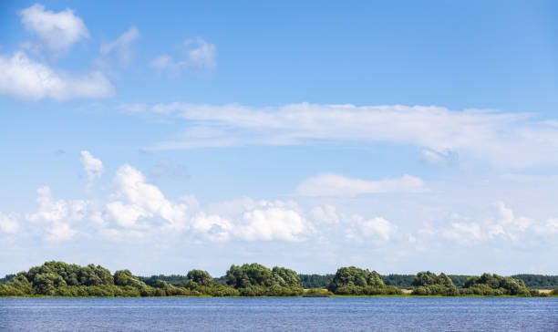 istock Coast of Volkhov River under blue sky 997381468