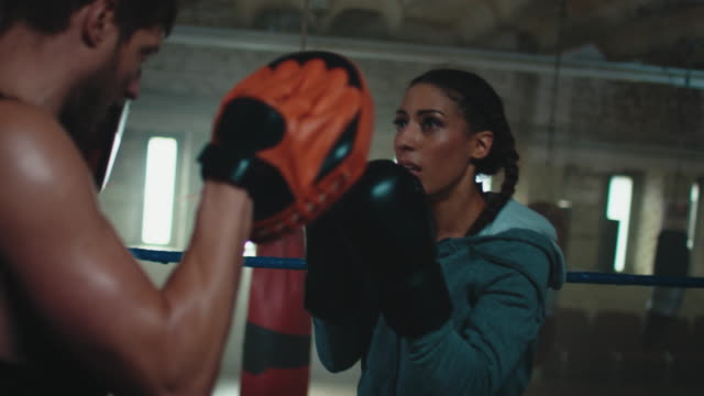 Boxing trainer teaches woman