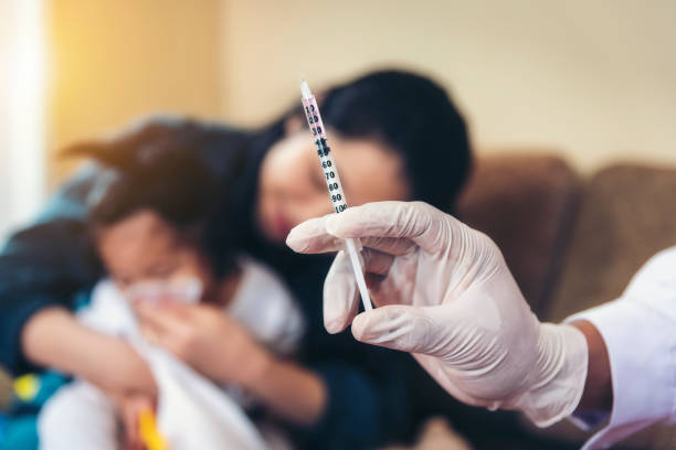 Asian doctors are checking syringes to treat children. stock photo