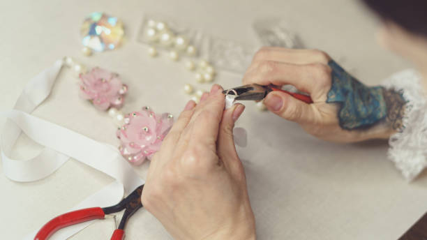 istock Girl is making jewelry 997389244