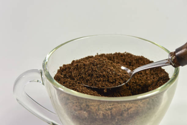 istock Spoon filled with coffee powder on white background. 997393942