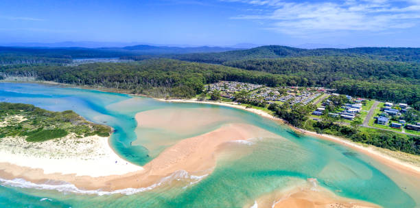 Durras Inlet separates north and south Durras coastal townships Durras Inlet separates North and South Durras townships.  In view is the popular Durras Lake North Park in Murramarang National Park, a great holiday vacation spot. shoalhaven stock pictures, royalty-free photos & images