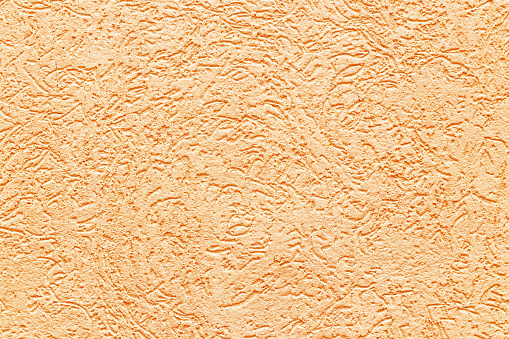 Texture of a fragment of a wall of a modern structure of yellow color. Harshness in the style of bark beetle. A background for design and creative work. Decoration and exterior decoration of the build