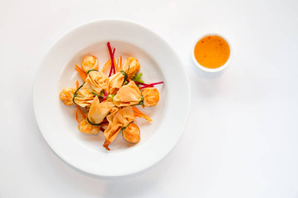 Thai traditional Fried spring rolls ( Money bag ) with sweet plum sauce on white backgruond