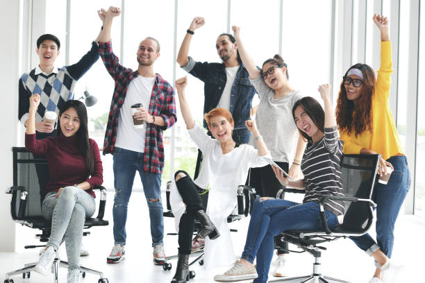 istock Group of businesspersons feeling happy and cheering successful work 997428276