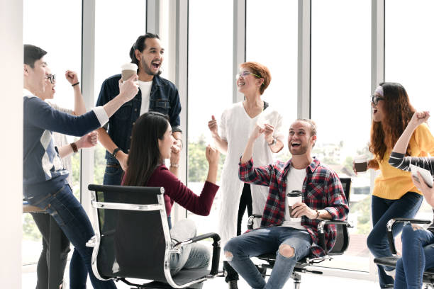 istock Group of businesspersons feeling happy and cheering successful work 997428542