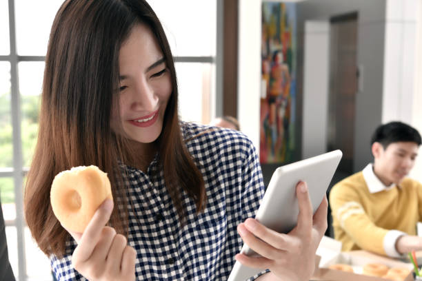 istock Young business person relaxing, having snacks during break time at the office 997428888
