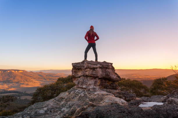 istock Hiker accomplish mountain climb standing on pinnacle 997433254