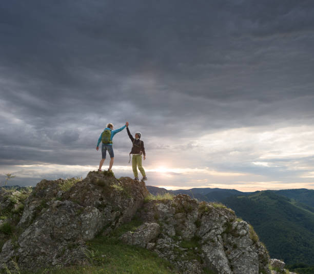 istock Hikers celebrating on the mountain top 997445558