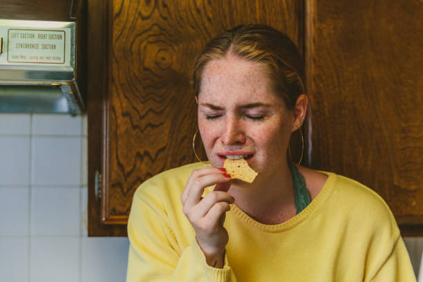 istock Sad Lonely Woman Eating Chip 997450054