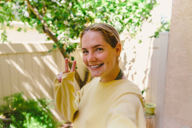 istock Teen Girl Taking Selfie While Making Peace Sign 997455246