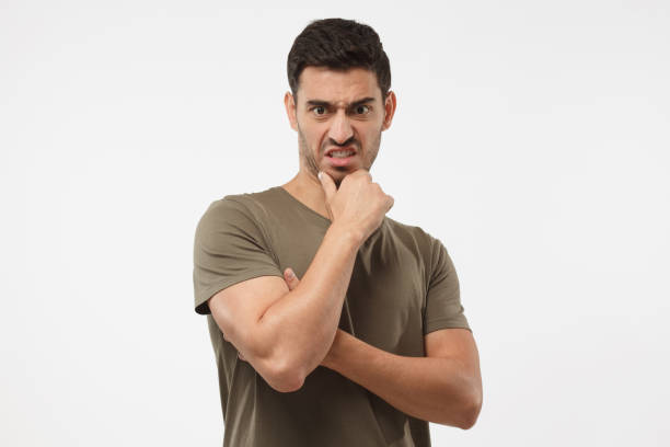 disguting! shocked young man looking at something unpleasant and bad, isolated on gray background. negative emotion concept - facial expression unpleasant smell shirt caucasian imagens e fotografias de stock