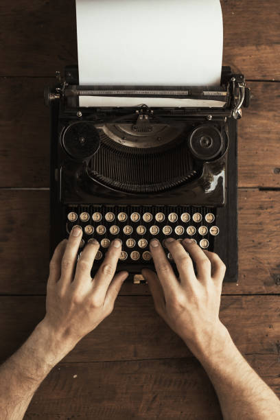 istock Young man's hands typing on an antique vintage typewriter 997462324