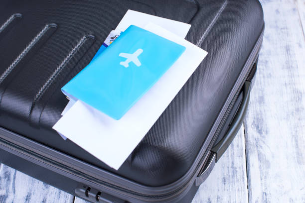 istock Documents for the flight and passport, suitcase. Trip on vacation. Copy space 997463150