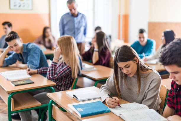 istock Teenage classmates cooperating during a class at high school. 997473412