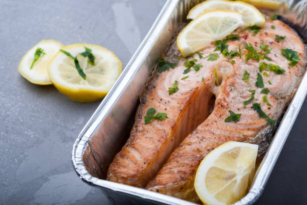 istock Salmon slice with a lemon and green parsley 997481868